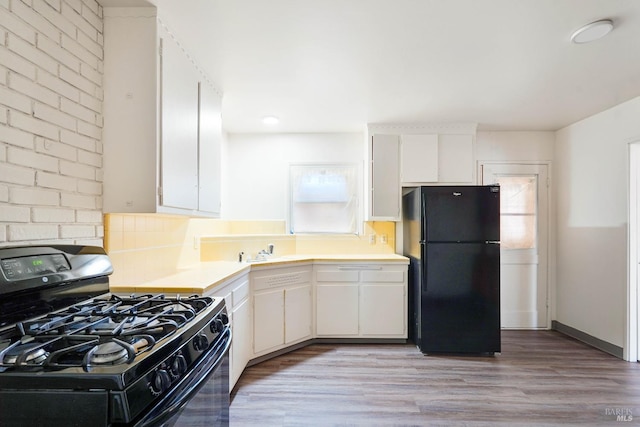 2409 Springs Rd, Vallejo, CA 94591 - kitchen featuring black appliances, light countertops, white cabinets, light wood-style floors, and backsplash