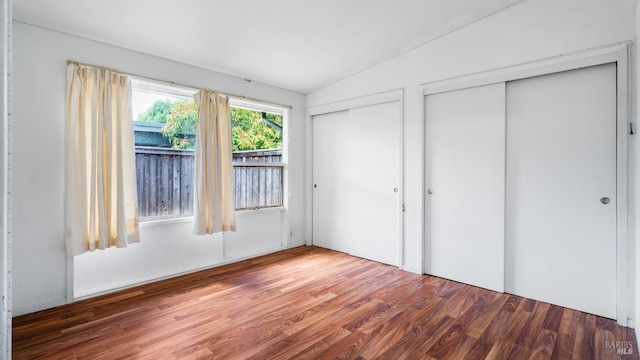 375 Las Colindas Rd, San Rafael, CA 94903 - unfurnished bedroom with multiple closets, wood finished floors, and vaulted ceiling