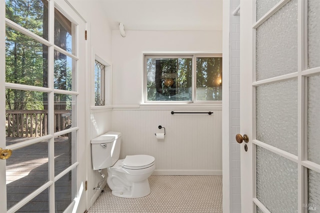 17075 Fitzpatrick Ln, Occidental, CA 95465 - bathroom with healthy amount of natural light, toilet, and a wainscoted wall