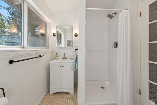 17075 Fitzpatrick Ln, Occidental, CA 95465 - full bathroom featuring a shower stall, tile patterned flooring, vanity, and wainscoting