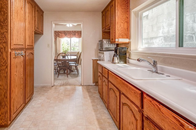 32 Romine Way, Vallejo, CA 94591 - kitchen featuring a sink, brown cabinets, light countertops, and a ceiling fan