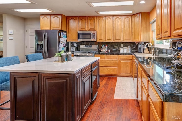 32 Romine Way, Vallejo, CA 94591 - kitchen featuring appliances with stainless steel finishes, a sink, dark wood-style flooring, and decorative backsplash