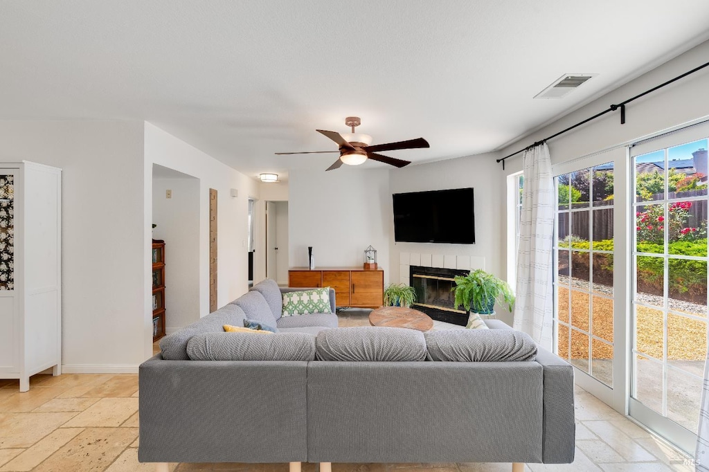 364 Columbia Cir, Benicia, CA 94510 - living area with stone tile flooring, ceiling fan, baseboards, and a tile fireplace