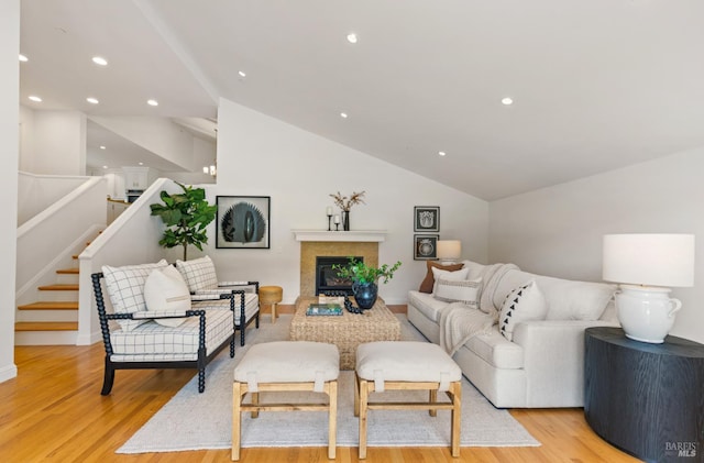 91 Round Hill Rd, Tiburon, CA 94920 - living area featuring light wood-style floors, vaulted ceiling, a glass covered fireplace, and stairs
