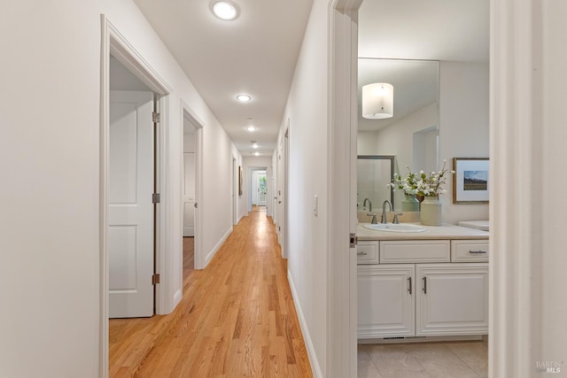 91 Round Hill Rd, Tiburon, CA 94920 - hallway with a sink, light wood-type flooring, recessed lighting, and baseboards