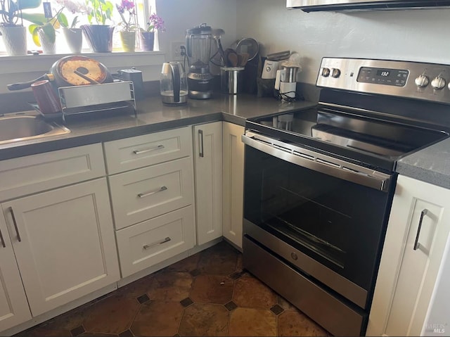 26 Fairfax Unit C, San Rafael, CA 94901 - kitchen featuring stainless steel electric range oven, white cabinetry, and plenty of natural light