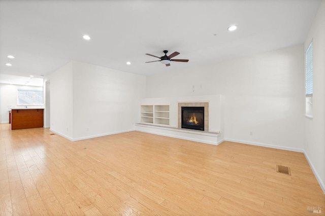 58 Randolph St, Napa, CA 94559 - unfurnished living room with light wood finished floors, baseboards, ceiling fan, recessed lighting, and a tiled fireplace