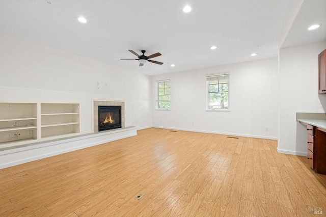 58 Randolph St, Napa, CA 94559 - unfurnished living room featuring light wood-style floors, built in shelves, a ceiling fan, recessed lighting, and a tile fireplace