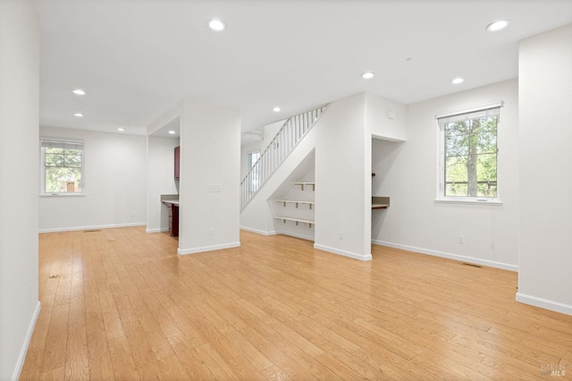 58 Randolph St, Napa, CA 94559 - unfurnished living room with healthy amount of natural light, light wood finished floors, baseboards, stairway, and recessed lighting