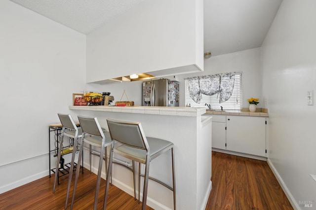 4214 Saturn Way, Union City, CA 94587 - kitchen with stainless steel fridge, tile counters, dark wood-style floors, and white cabinetry