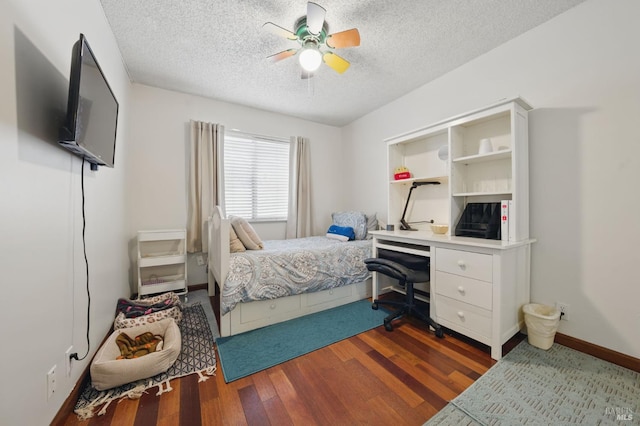 4214 Saturn Way, Union City, CA 94587 - bedroom with a textured ceiling, a desk, dark wood-style floors, a ceiling fan, and baseboards
