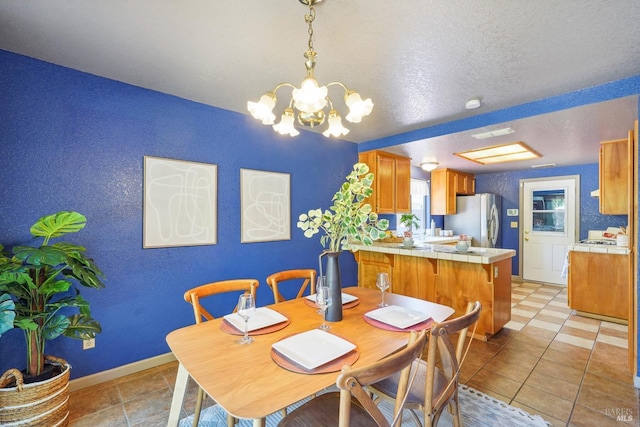 766 Morissette Way, Vacaville, CA 95687 - dining room featuring a chandelier, baseboards, a textured ceiling, and light tile patterned floors