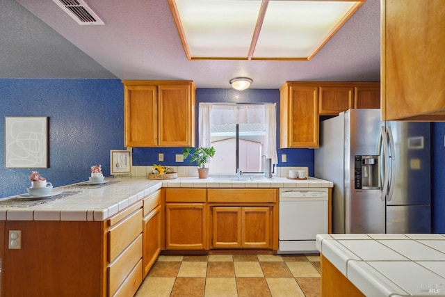 766 Morissette Way, Vacaville, CA 95687 - kitchen with stainless steel refrigerator with ice dispenser, white dishwasher, a sink, and brown cabinetry