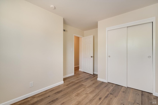 1828 Trower Ave, Napa, CA 94558 - unfurnished bedroom with light wood finished floors, baseboards, and a closet