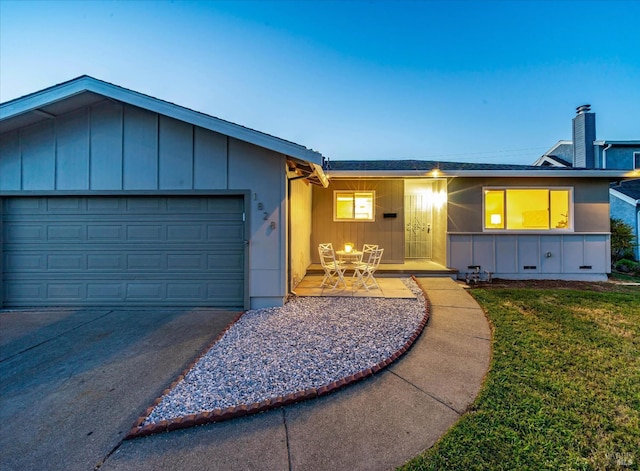 1828 Trower Ave, Napa, CA 94558 - ranch-style house with driveway, board and batten siding, a garage, and a front lawn