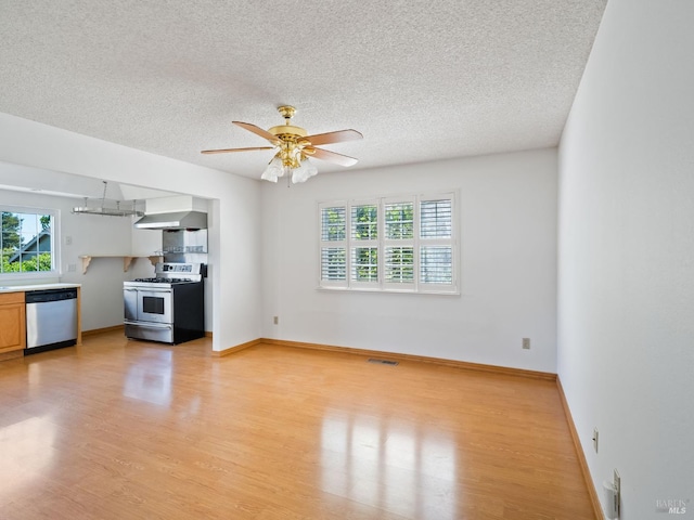 175 Temelec Cir, Sonoma, CA 95476 - unfurnished living room featuring healthy amount of natural light, light wood-type flooring, a textured ceiling, and a ceiling fan
