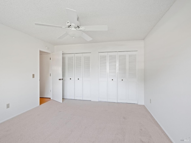 175 Temelec Cir, Sonoma, CA 95476 - unfurnished bedroom featuring two closets, carpet flooring, a ceiling fan, and a textured ceiling