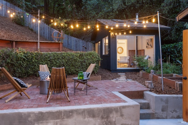 view of patio with an outbuilding and fence