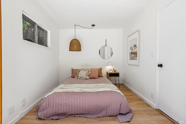 bedroom with wood finished floors and baseboards