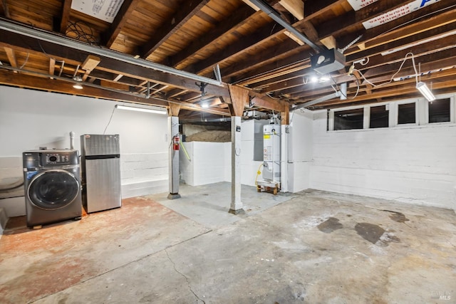 unfinished below grade area with washer / clothes dryer, gas water heater, and freestanding refrigerator