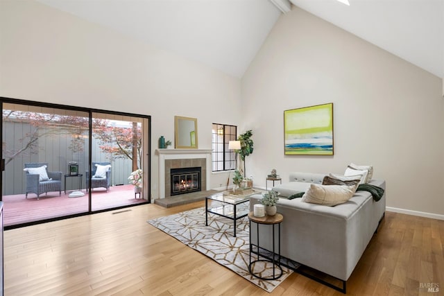 20912 Via Colombard, Sonoma, CA 95476 - living area with high vaulted ceiling, wood finished floors, healthy amount of natural light, a tiled fireplace, and beam ceiling