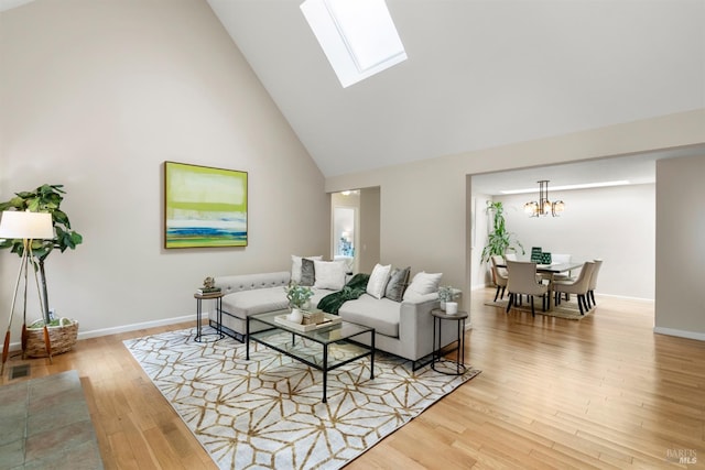 20912 Via Colombard, Sonoma, CA 95476 - living room with light wood-type flooring, a chandelier, high vaulted ceiling, a skylight, and baseboards
