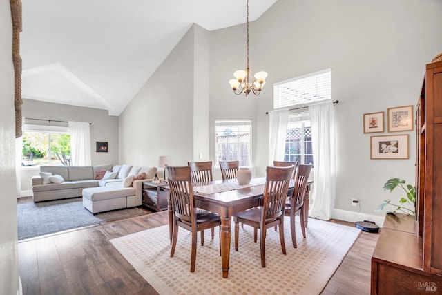 2812 Silver Fox Cir, Fairfield, CA 94534 - dining area with high vaulted ceiling, a chandelier, wood finished floors, and baseboards