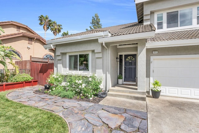 2812 Silver Fox Cir, Fairfield, CA 94534 - view of exterior entry featuring fence, a tiled roof, stucco siding, and concrete driveway