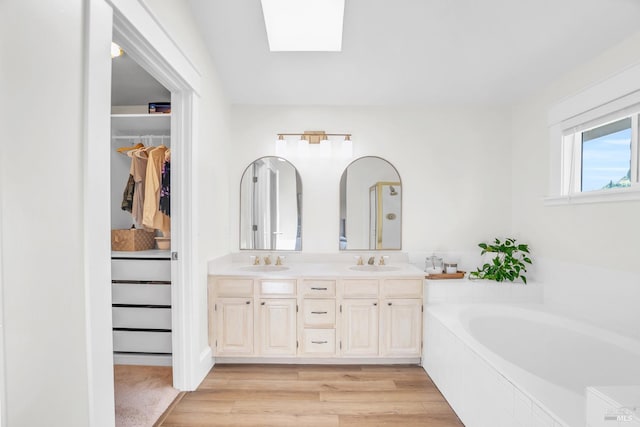 2812 Silver Fox Cir, Fairfield, CA 94534 - full bath featuring a skylight, wood finished floors, double vanity, a spacious closet, and a bath