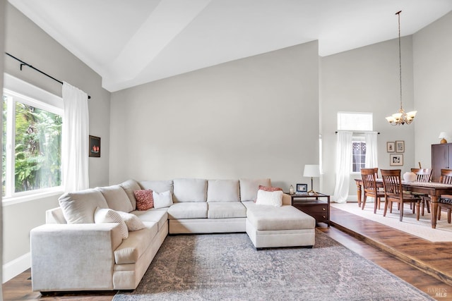 2812 Silver Fox Cir, Fairfield, CA 94534 - living room with a chandelier, high vaulted ceiling, wood finished floors, and baseboards