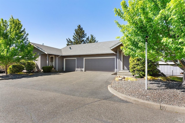 431 University St, Healdsburg, CA 95448 - view of front of home with an attached garage, asphalt driveway, and roof with shingles