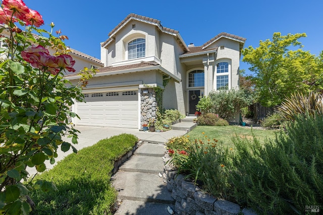 2130 Camenson St, Napa, CA 94558 - view of front of house featuring stucco siding, concrete driveway, a garage, a tiled roof, and stone siding