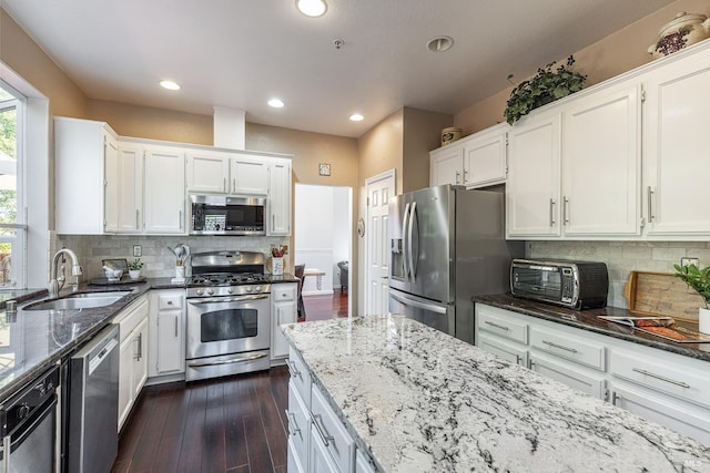 2130 Camenson St, Napa, CA 94558 - kitchen featuring appliances with stainless steel finishes, dark stone counters, white cabinetry, recessed lighting, and dark wood-style flooring