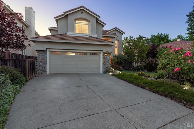 2130 Camenson St, Napa, CA 94558 - traditional home with stone siding, an attached garage, concrete driveway, stucco siding, and a tile roof