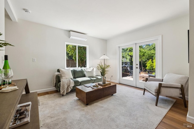 231 Railroad Ave, Woodacre, CA 94973 - living area featuring an AC wall unit, plenty of natural light, french doors, and wood finished floors