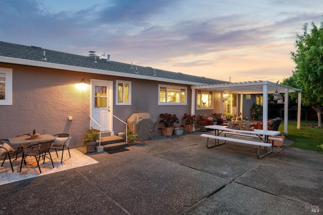 23180 Maffei Rd, Sonoma, CA 95476 - back of house at dusk with outdoor dining space, stucco siding, a patio area, a pergola, and roof with shingles