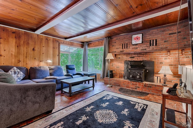 20215 Willow Rd, Monte Rio, CA 95462 - living room featuring wooden ceiling, a wood stove, wood walls, wood finished floors, and beam ceiling