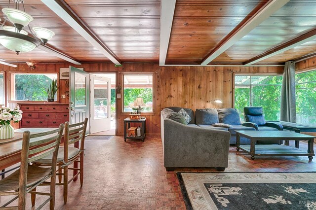 20215 Willow Rd, Monte Rio, CA 95462 - living room featuring wooden ceiling, brick patterned flooring, healthy amount of natural light, beam ceiling, and wood walls