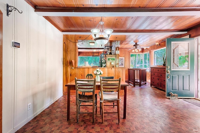20215 Willow Rd, Monte Rio, CA 95462 - dining area with wood ceiling, wood walls, a chandelier, a ceiling fan, and beam ceiling