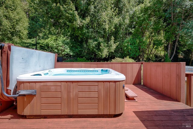 20215 Willow Rd, Monte Rio, CA 95462 - wooden deck with a hot tub and a wooded view