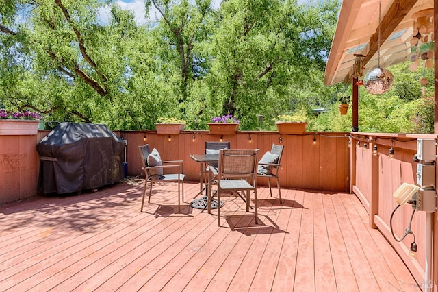 20215 Willow Rd, Monte Rio, CA 95462 - wooden terrace featuring outdoor dining space, area for grilling, and view of scattered trees