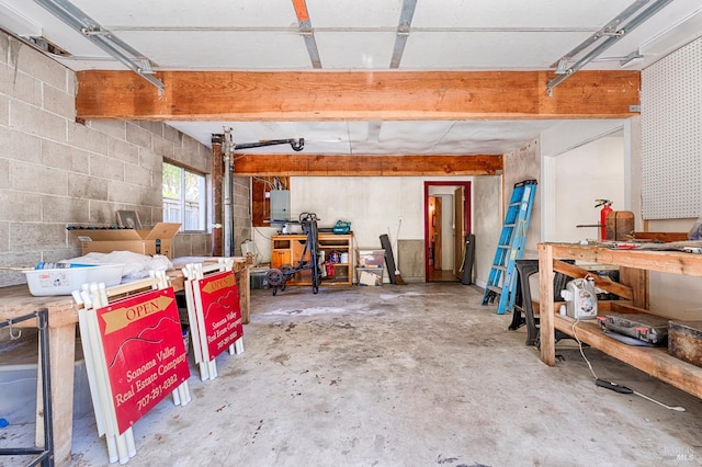 20215 Willow Rd, Monte Rio, CA 95462 - garage with a workshop area, electric panel, and concrete block wall