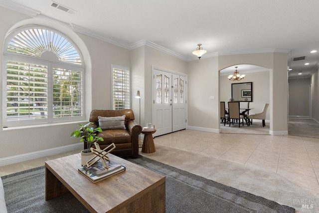 3704 Chapparal Ct, Fairfield, CA 94534 - living room featuring arched walkways, baseboards, light tile patterned floors, a chandelier, and ornamental molding