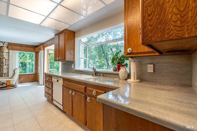 436 Candlelight Dr, Santa Rosa, CA 95403 - kitchen featuring dishwasher, a sink, brown cabinetry, decorative backsplash, and light countertops