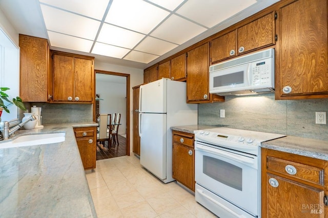 436 Candlelight Dr, Santa Rosa, CA 95403 - kitchen with white appliances, brown cabinets, a sink, decorative backsplash, and light tile patterned floors