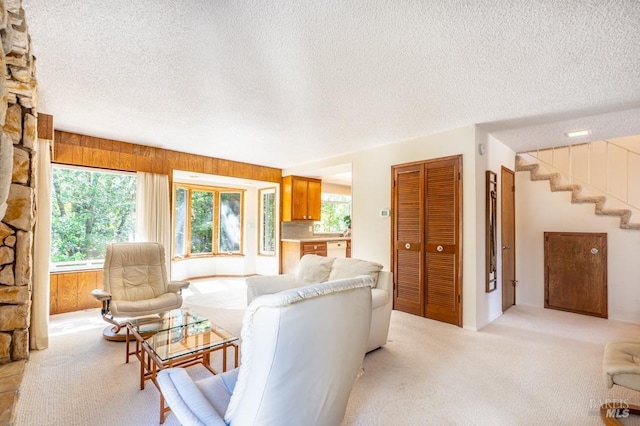 436 Candlelight Dr, Santa Rosa, CA 95403 - living area featuring a textured ceiling, light colored carpet, and wood walls