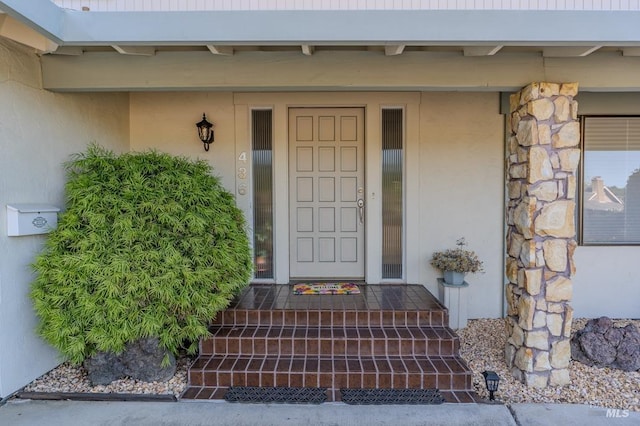 436 Candlelight Dr, Santa Rosa, CA 95403 - view of exterior entry with stucco siding, stone siding, and covered porch
