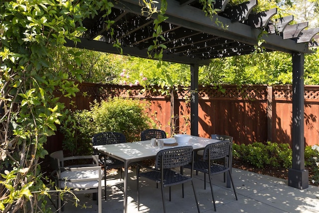 view of patio featuring a pergola, a fenced backyard, and outdoor dining space