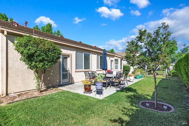 670 Turnberry Ter, Rio Vista, CA 94571 - rear view of house featuring stucco siding, a lawn, and a patio