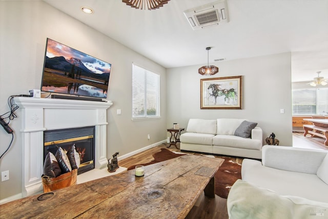 670 Turnberry Ter, Rio Vista, CA 94571 - living room featuring wood finished floors, plenty of natural light, baseboards, and a fireplace with flush hearth